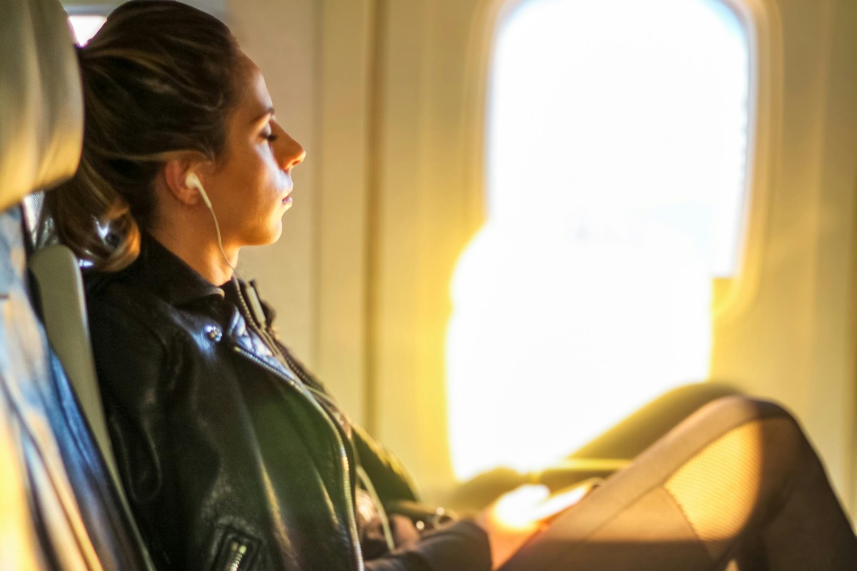 Passenger listening to audio during an airplane flight